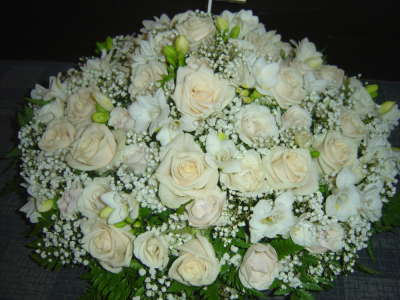 In loving Memory - A classic all-white funeral posy that includes white freesias, white roses, white carnations and gyps - the scent of freesias and roses combined is so heavenly!